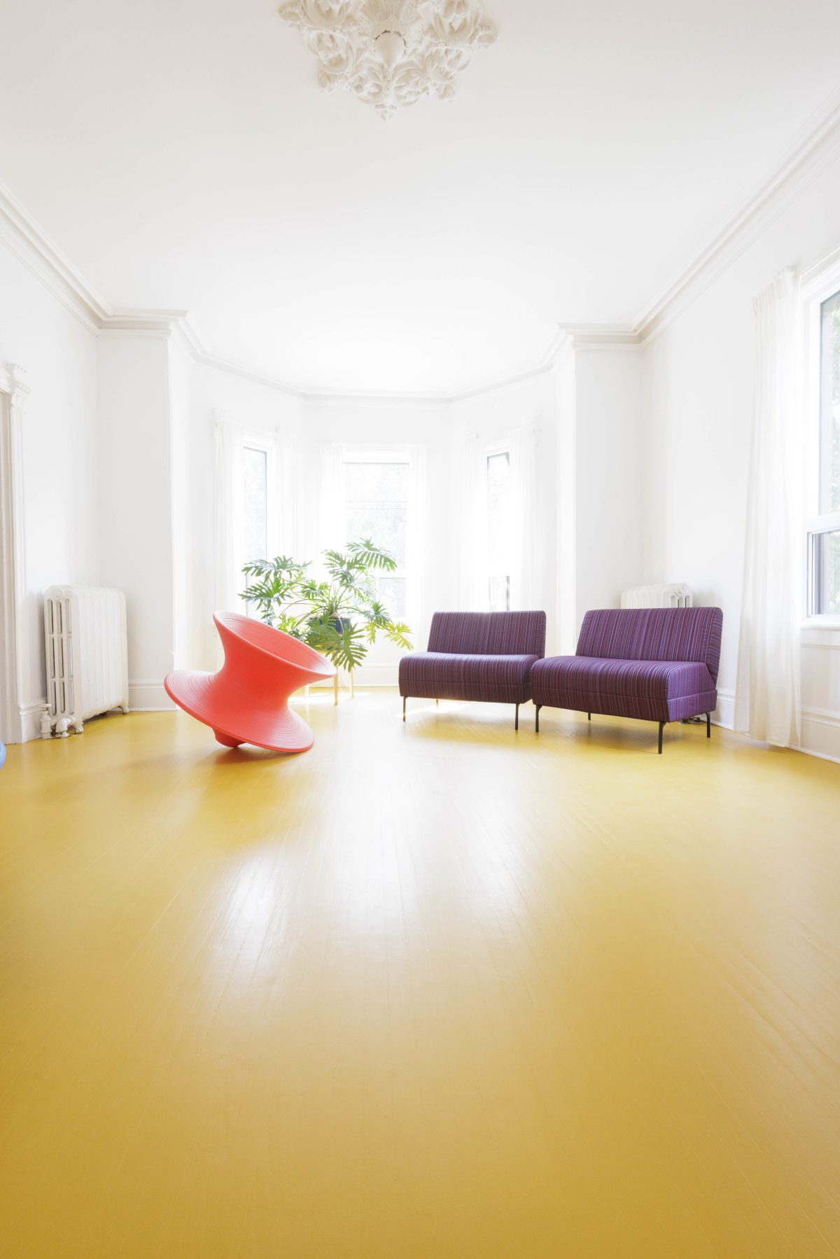 Breathtaking expansive space to be! White linen curtains glow. Sun yellow floors and large bay window shimmer in the sunlight.